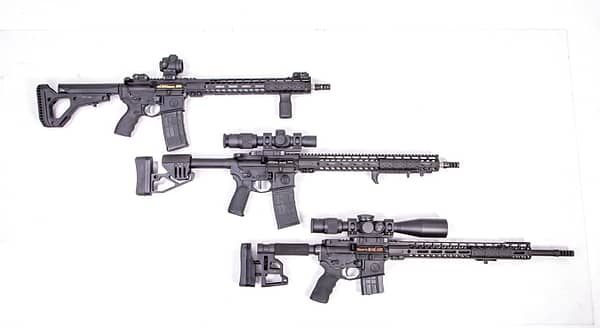 three ar rifles one on top of another